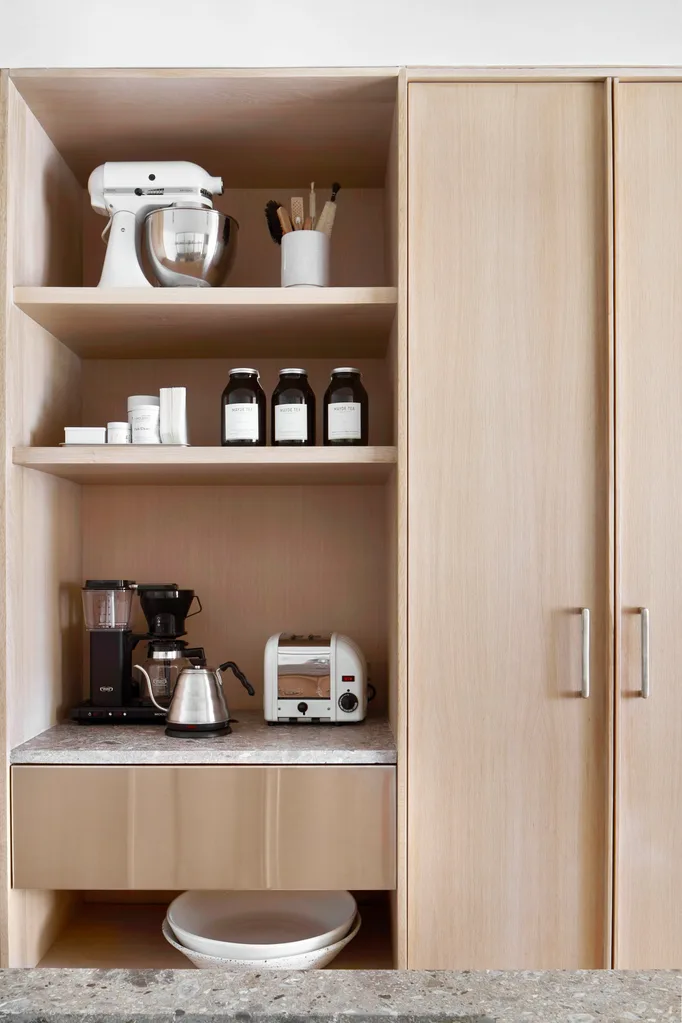 Wooden kitchen cabinetry with coffee station