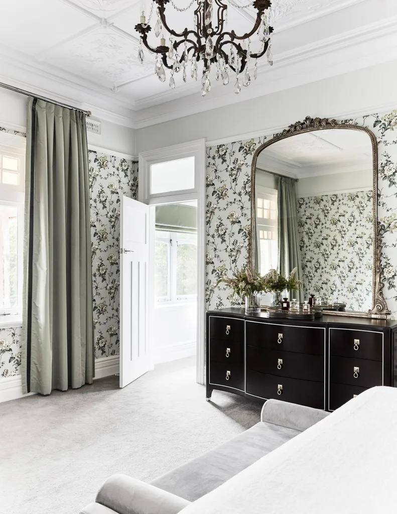 bedroom with antique mirror and black chest of drawers