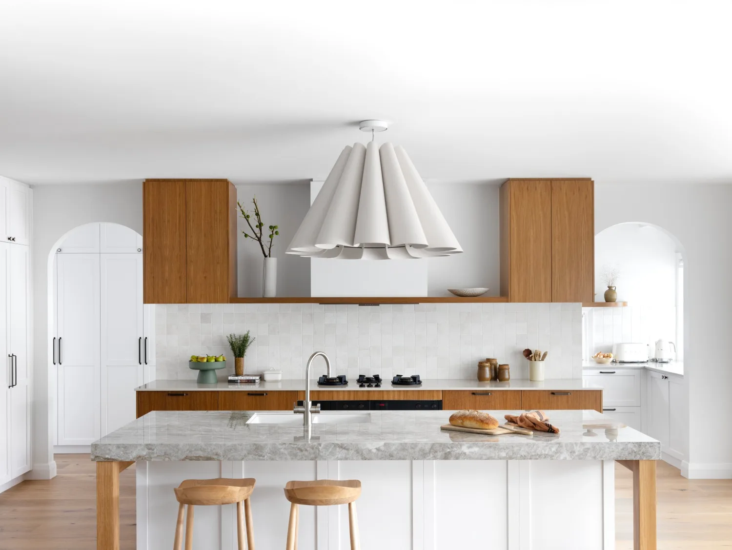 White kitchen with square splashback tiles and dekton island benchtop
