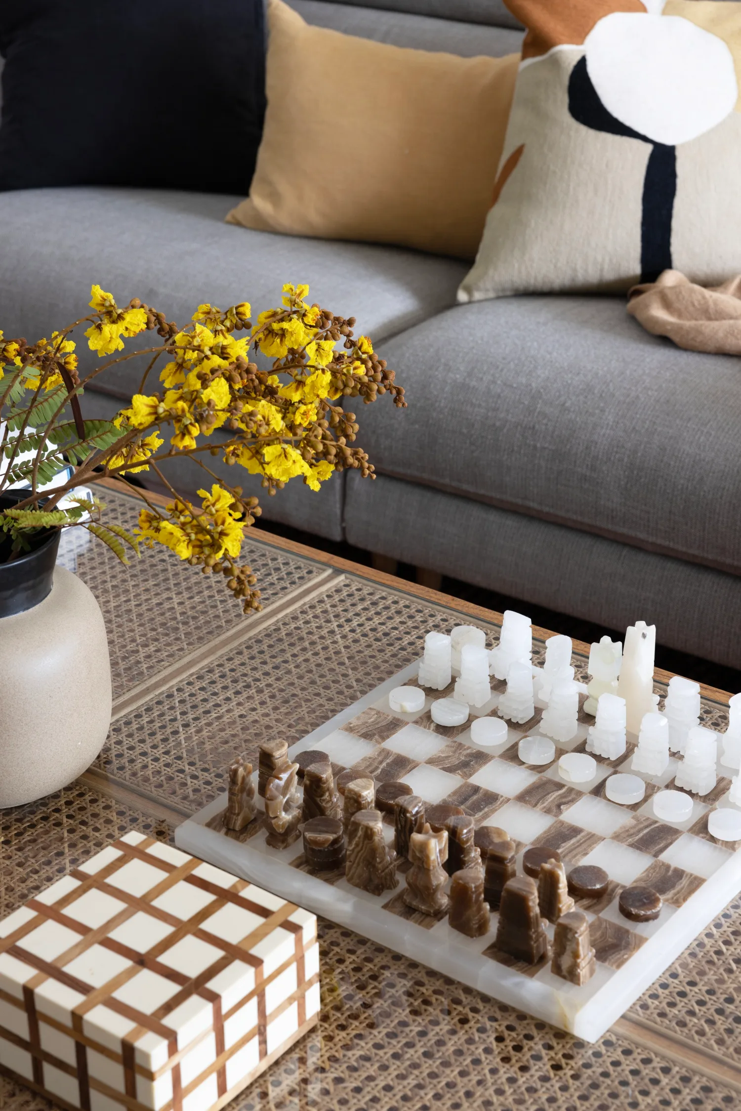 marble chess set on rattan coffee table