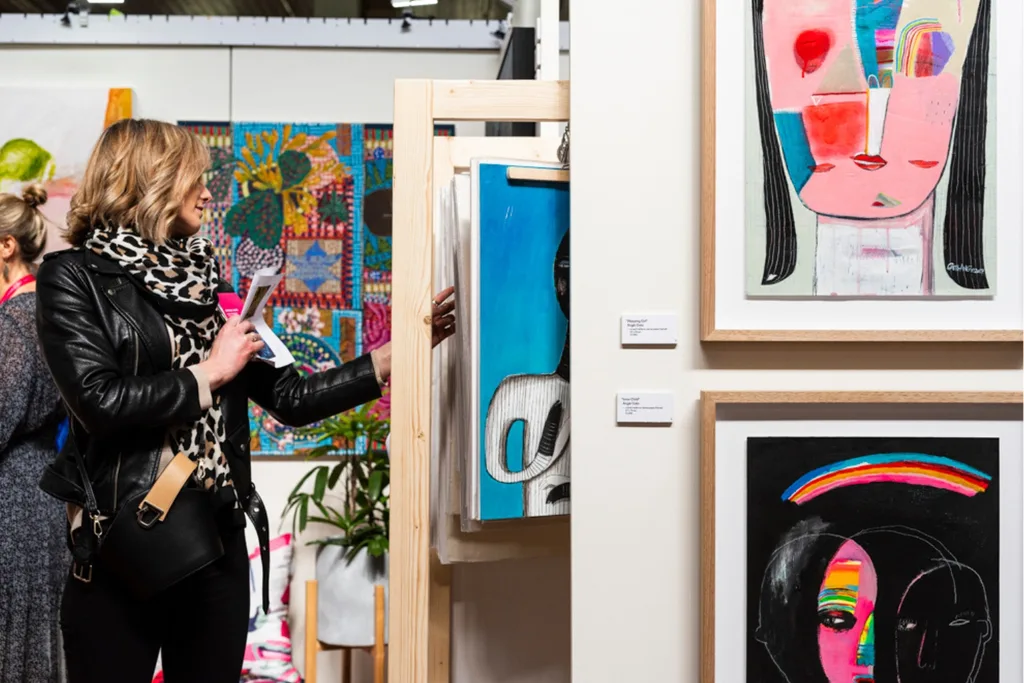 Customers perusing artwork at the Affordable Art Fair