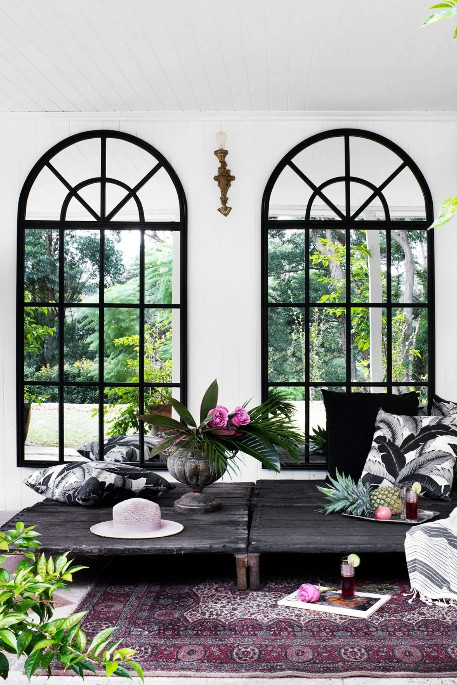 Large arched mirrors reflecting the garden