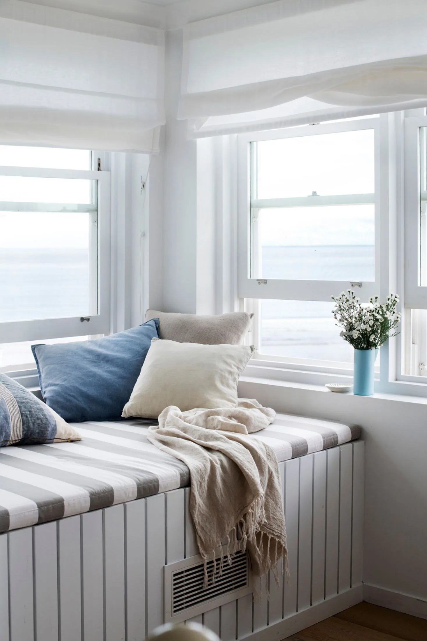 Window seat and day bed in beach house overlooking the ocean