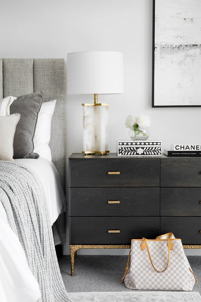 contemporary bedroom with dark timber bedside chest of drawers