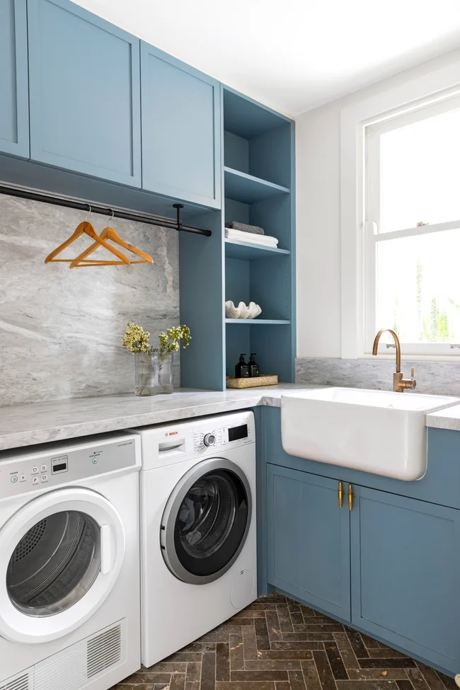 laundry with blue cabinetry