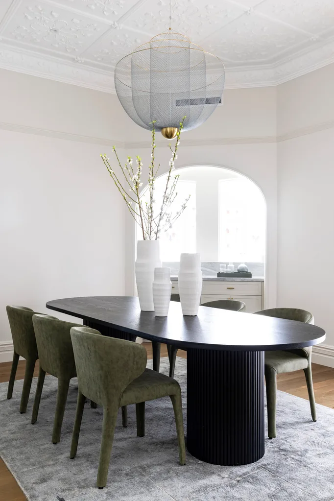 curved dining table with upholstered dining chairs