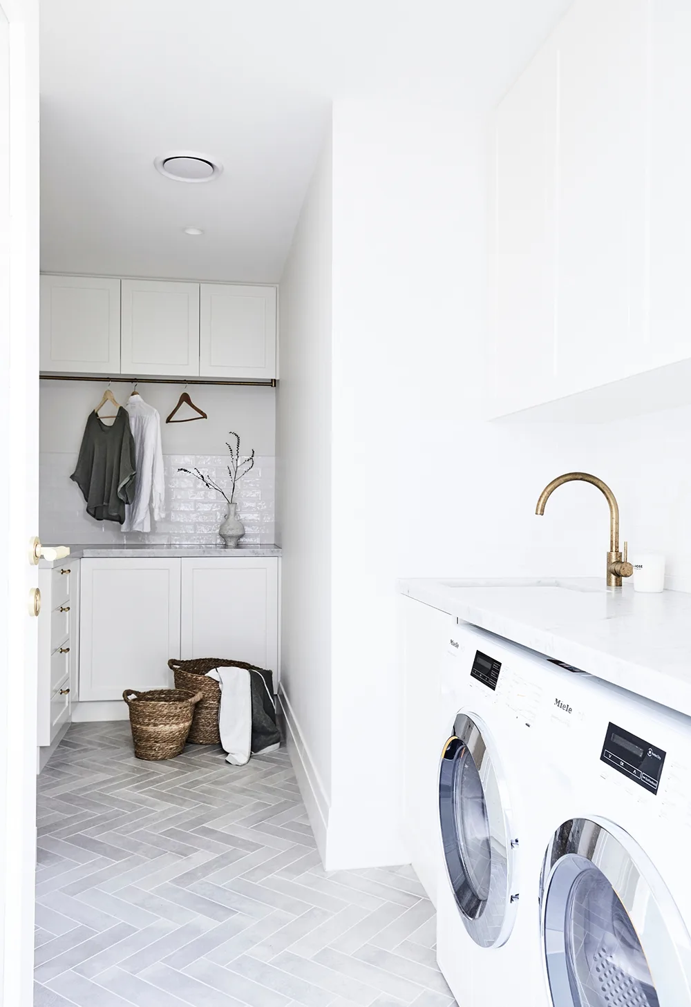 White modern laundry with two hampers