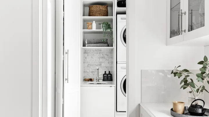 White laundry next to modern white kitchen