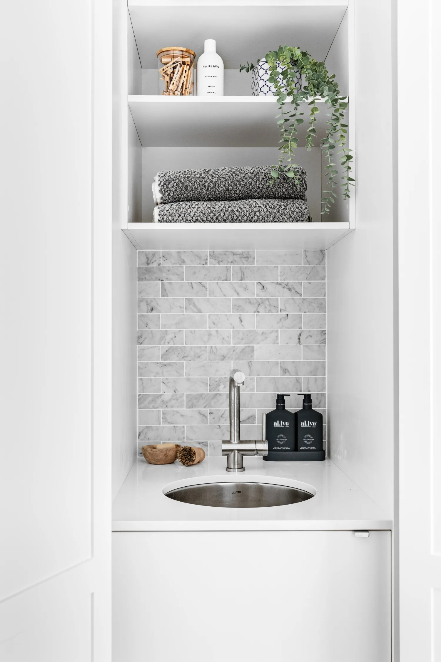 Modern white laundry with grey splashback tiles