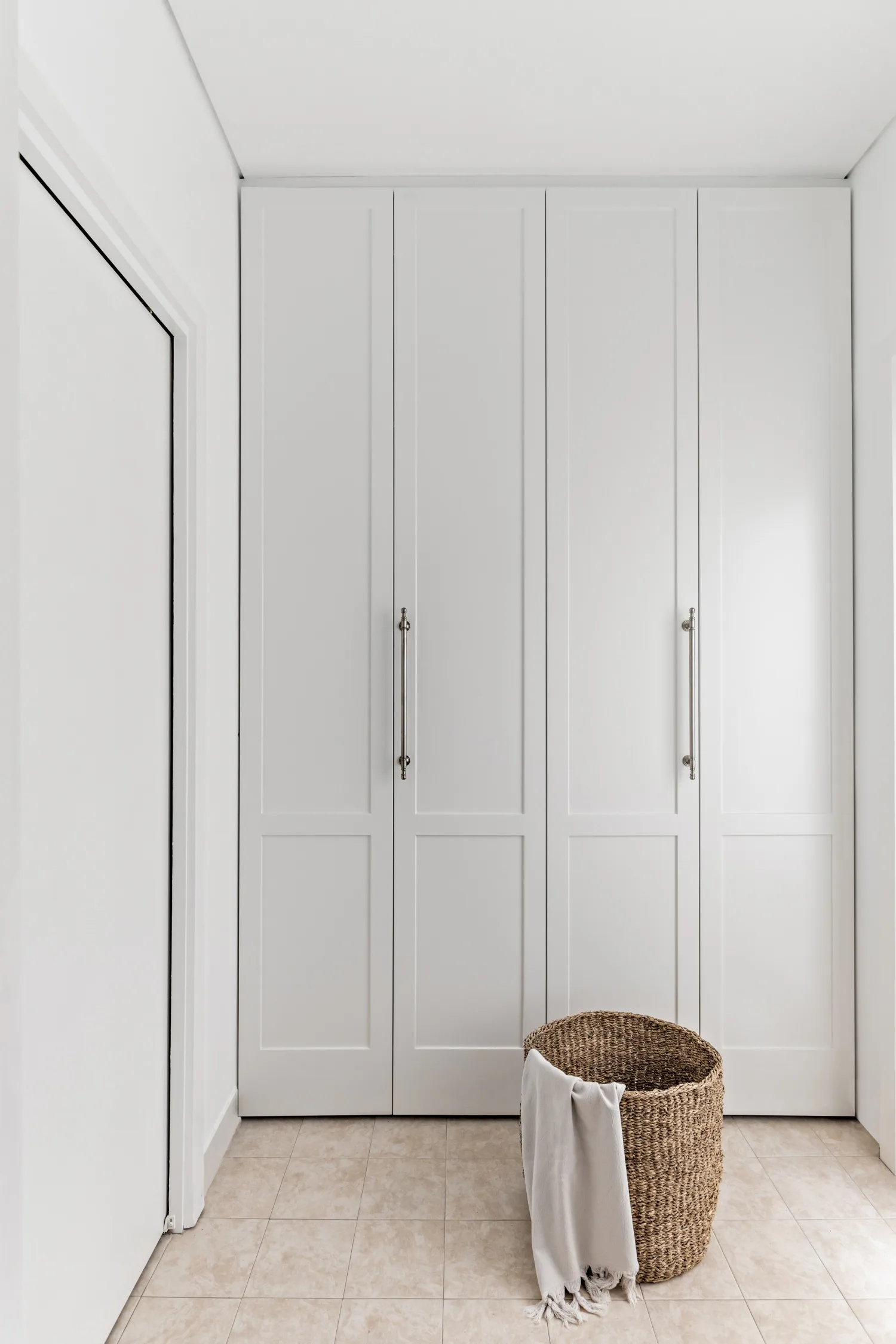 modern white laundry with light grey cabinets