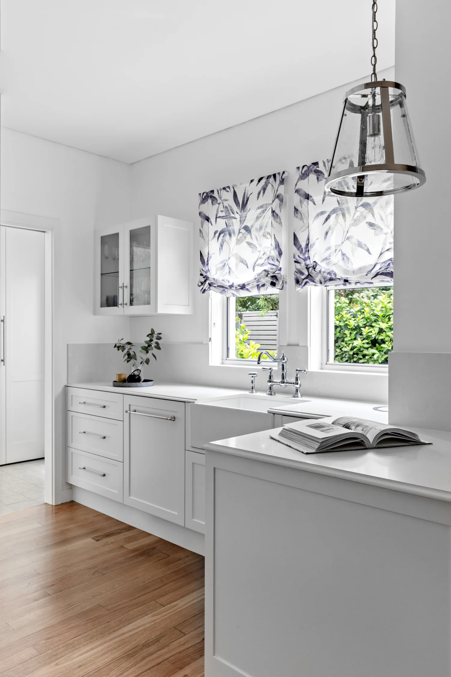 Modern white kitchen with linen blinds