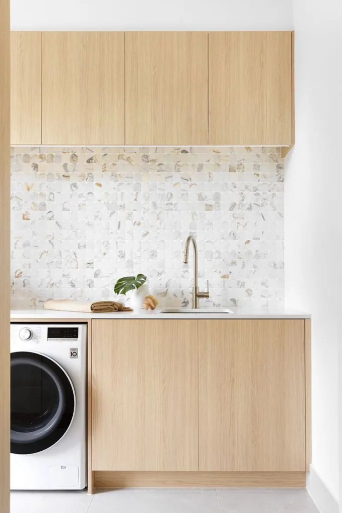 Laundry with light timber or veneer cabinetry with calacatta mosaic tiles