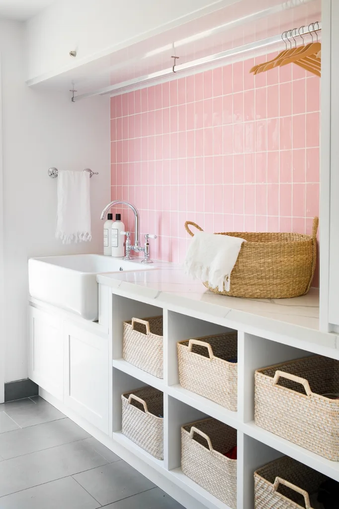 Laundry with pink tiled splashback