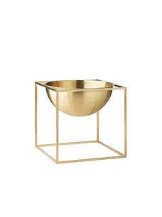 Golden bowl with a geometric square frame stand against a white background.