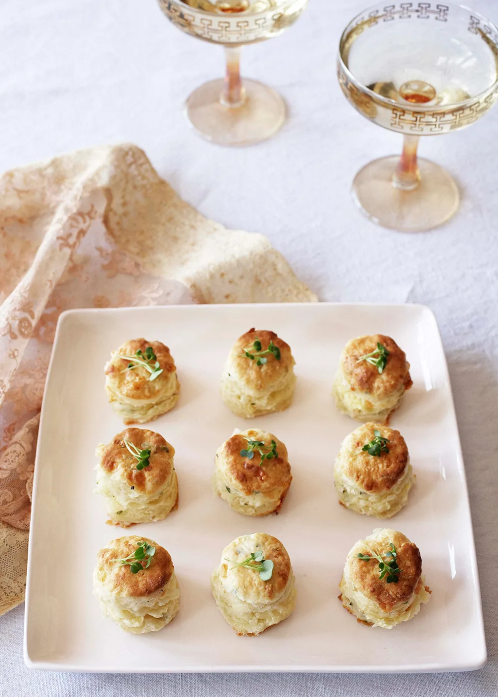 Nine cheese and thyme scones on a pink platter.