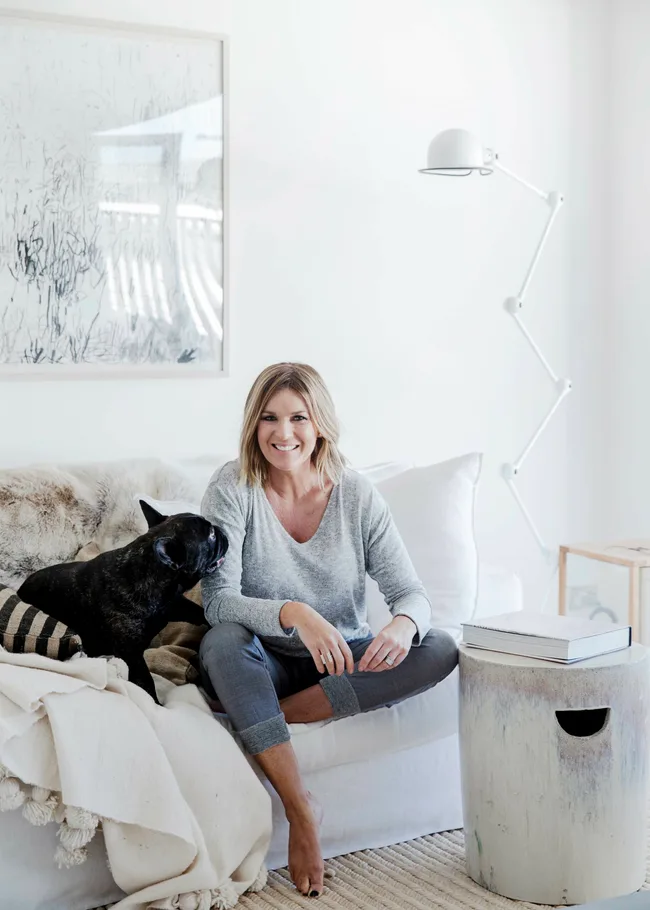 Kylie Gillies on lounge with dog