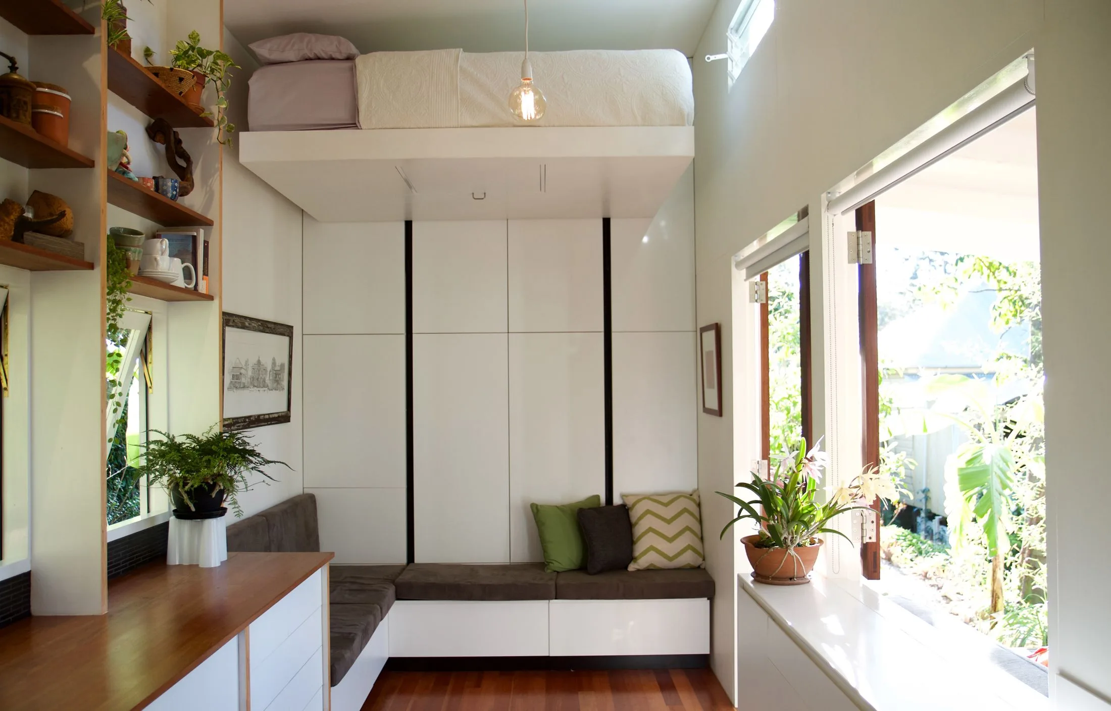 granny flat tiny home with raiseable bed above a living area