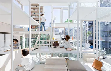 Open-plan, minimalist home with large windows and a multi-level interior; people reading and organizing books on a shelf.