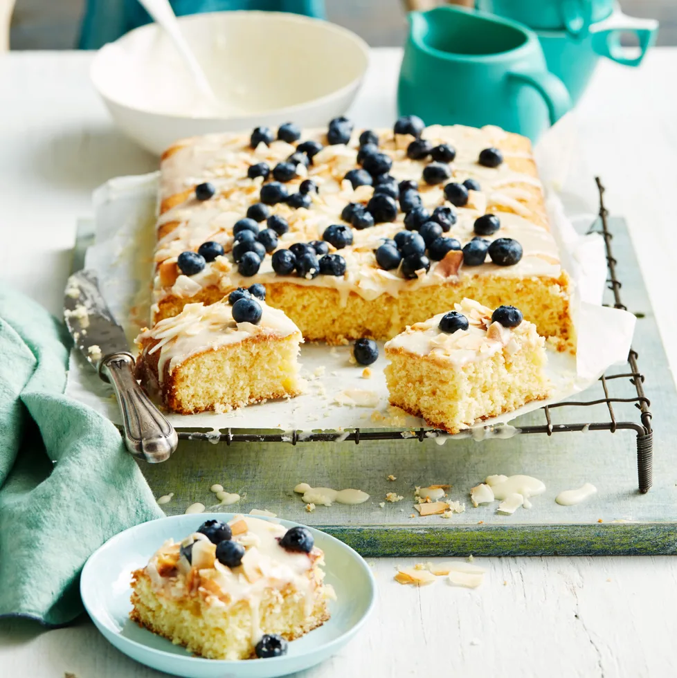 pineapple coconut cake with blueberries on top of running royal icing