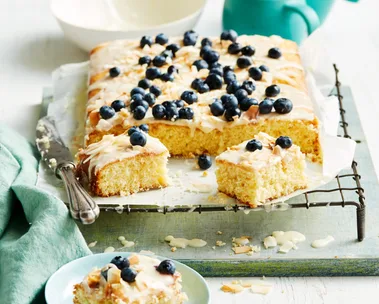 pineapple coconut cake with blueberries on top of running royal icing