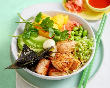poke bowl with edamame vegetables and chopsticks on the side