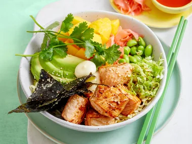 poke bowl with edamame vegetables and chopsticks on the side