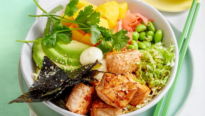 poke bowl with edamame vegetables and chopsticks on the side