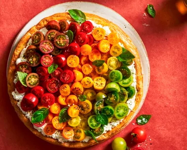 tomato tart with different coloured cherry tomatoes on top in line