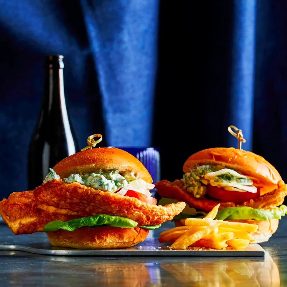 crispy fish burger with skewer sticking out of the top