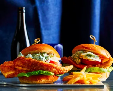 crispy fish burger with skewer sticking out of the top