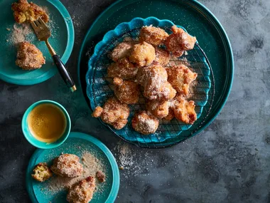 banana doughnuts in blue bowl piled up