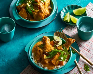 chicken curry in two bowls orangey colour with blue and teal colouring of bowls