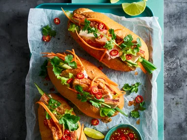 banh mi 3 rolls with pickled carrot pork belly and coriander on top