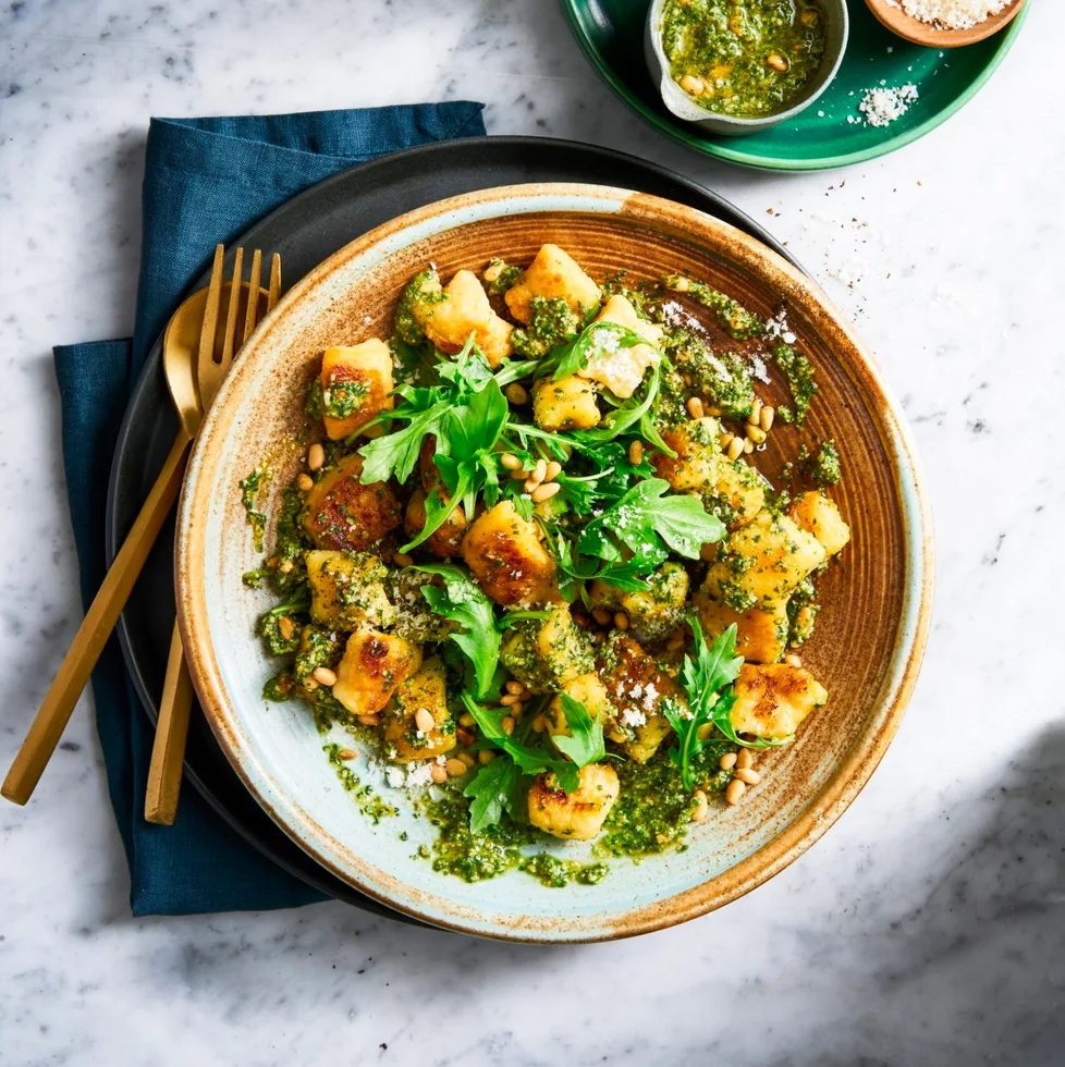 pesto gnocchi with basil pine nuts and rocket on top