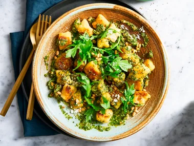 pesto gnocchi with basil pine nuts and rocket on top