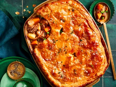 lamb pie with vegetables and one scoop taken out with spoon