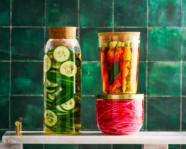 pickle recipe with cucumber pickles, carrot pickles and pickled onions in three separate jars