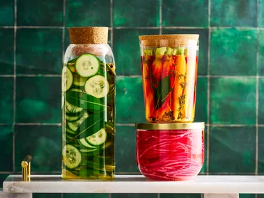 pickle recipe with cucumber pickles, carrot pickles and pickled onions in three separate jars