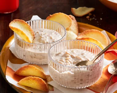 chai rice pudding in glass pudding cups with orange slices decorating it