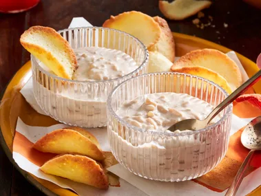 chai rice pudding in glass pudding cups with orange slices decorating it