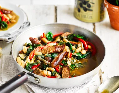 Beef sausages served with cannellini beans and vegetables