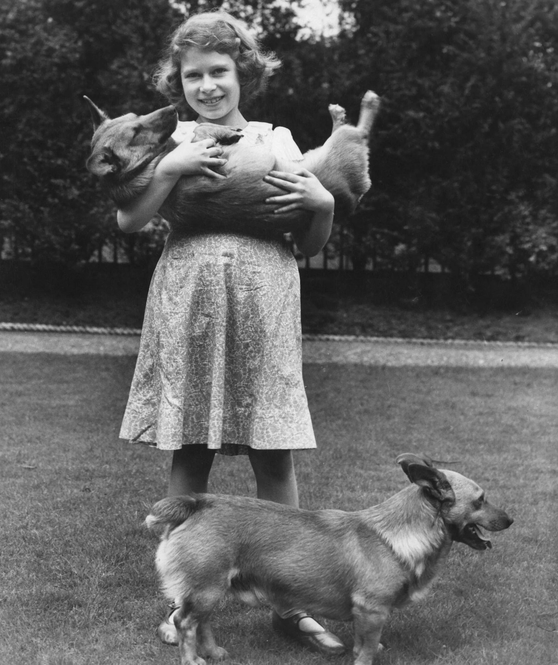 Then-Princess Elizabeth with her beloved corgis in this rare family photo of the future monarch.