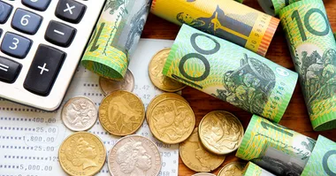 Australian notes and coins scattered on a table.