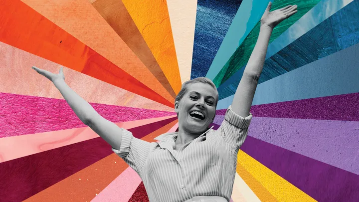 A grayscale photo of a joyful woman with arms raised, set against a vibrant, multicolored radial background.