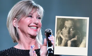 Olivia Newton-John smiling on stage holding a microphone, with a vintage photo of her in the foreground.