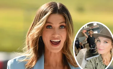 Woman smiling in a blue blazer with inset photo of her taking a selfie on a film set, wearing a hat.