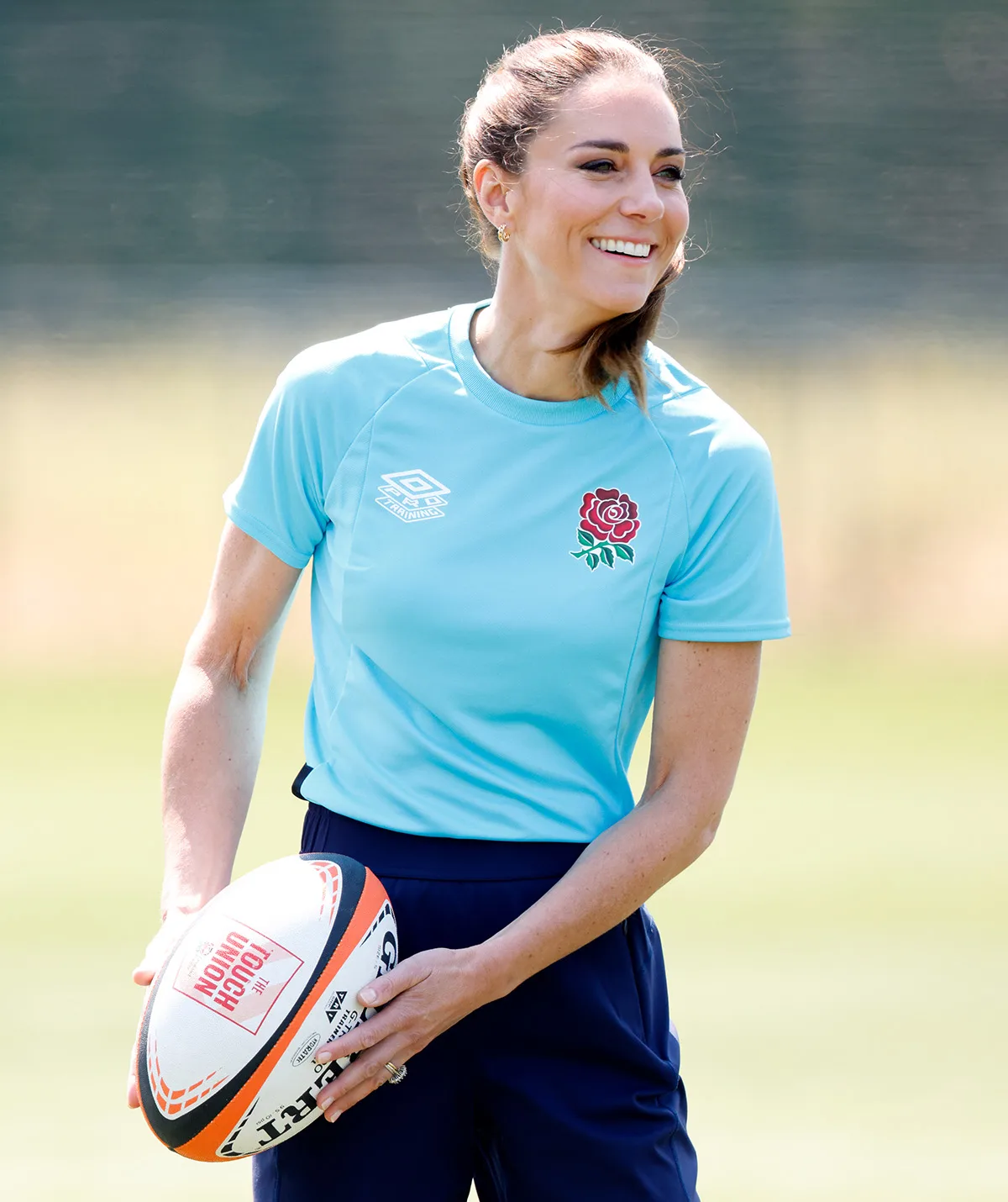 Princess Catherine wearing a sports jersey and playing touch rugby