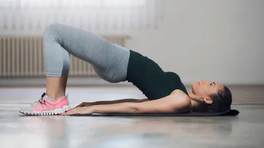 womn holding glute bridge