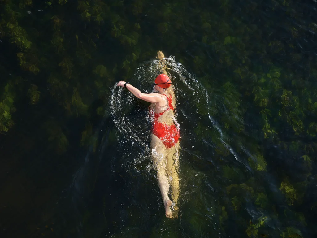 UK, Bedfordshire, Great Barford, River Great Ouse, female wild swimmer swimming in a river