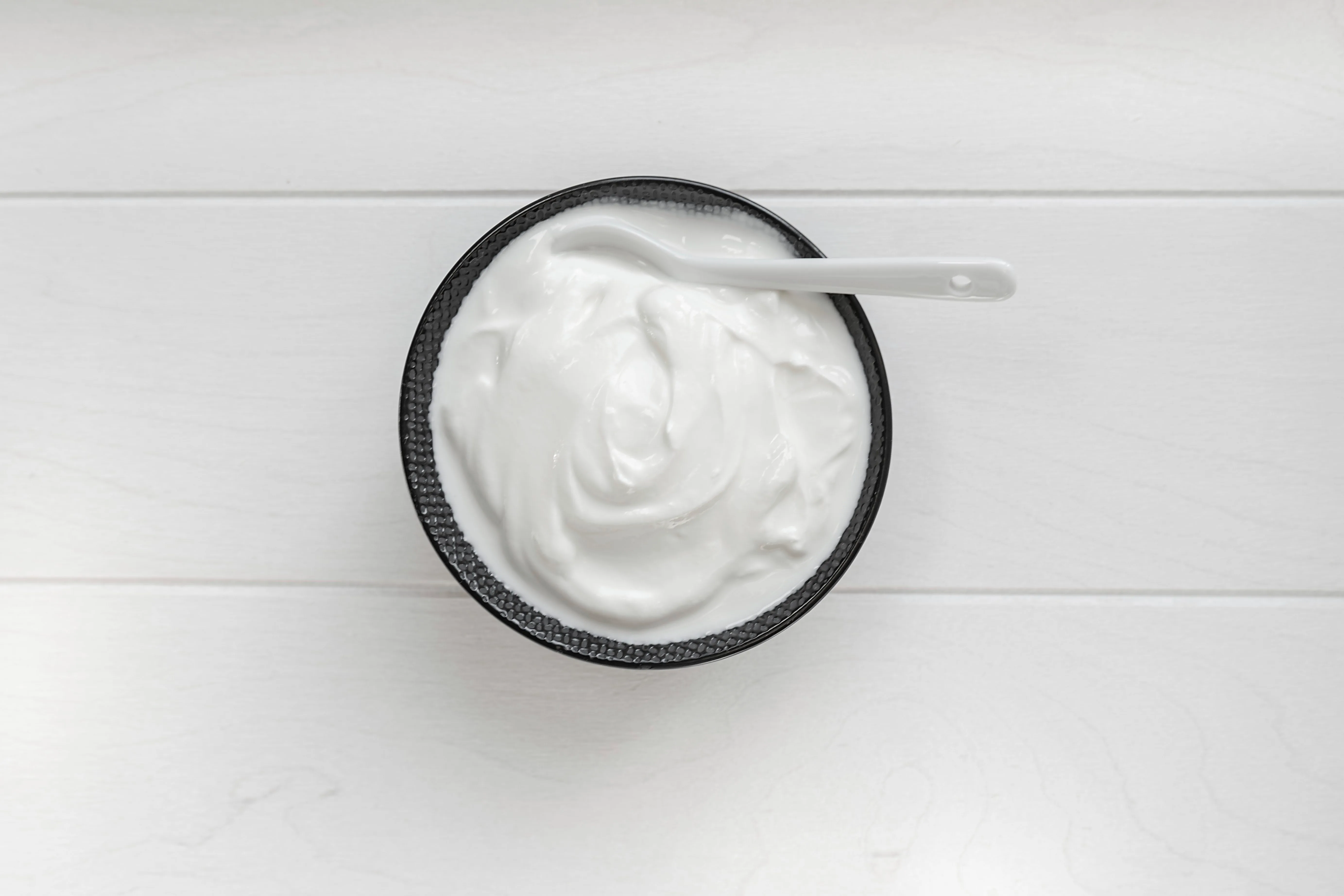 yogurt in bowl on wooden table. healthy eating